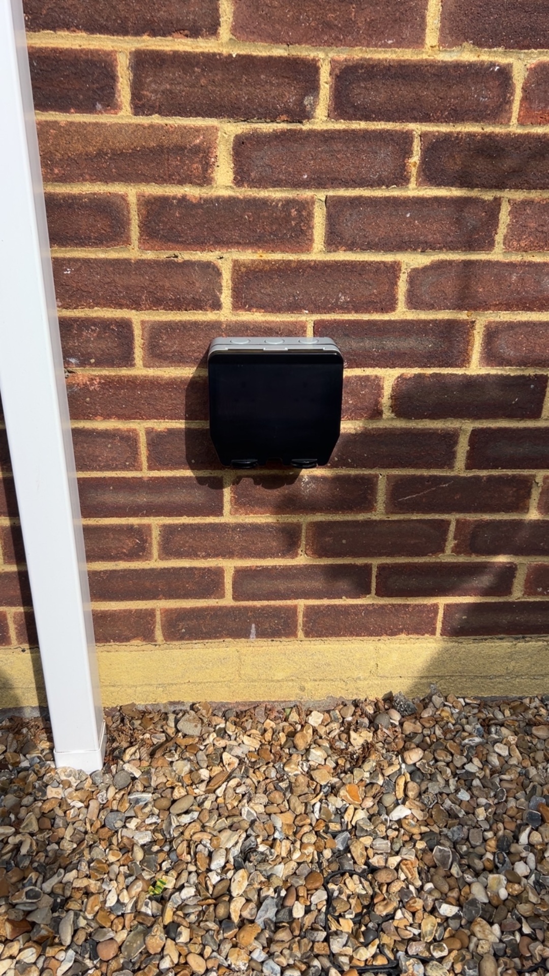 Weatherproof outdoor socket installed on brick wall by LJK Electrical