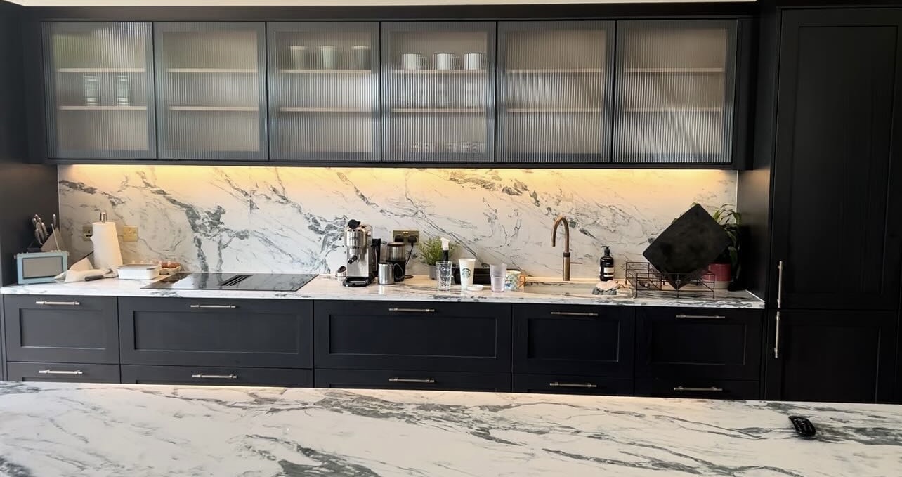 Kitchen with under-cabinet LED lighting and marble worktops by LJK Electrical